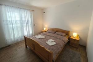 a bedroom with a bed with two towels on it at Family friendly house with a swimming pool Cunski, Losinj - 24170 in Cunski