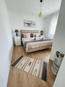 a bedroom with a bed and a rug on the floor at Apartments by the sea Marina, Trogir - 24180 in Marina