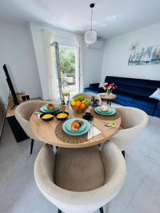 a table with plates of food on it in a living room at Apartments by the sea Marina, Trogir - 24180 in Marina