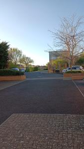 an empty parking lot with a building in the background at Spacious Cheltenham Flat with Free Allocated Parking in Cheltenham