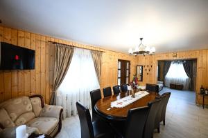 a dining room with a table and chairs at Cabana pe Vale in Marga