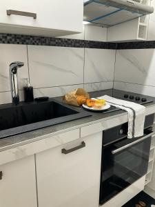 a kitchen with a plate of food on a counter at Le Zénith appartement type T2 in Cayenne