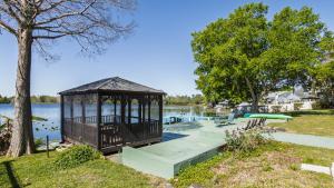 a gazebo in a park next to a lake at Lakefront Retreat - Boat - Fish - Close to all Orlando Parks - Disney - Universal - SeaWorld in Orlando