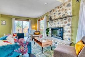a living room with a blue couch and a stone fireplace at Hot Tub Sauna Steam Room Arcades Airhockey in East Stroudsburg