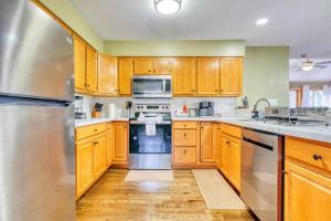 a kitchen with wooden cabinets and stainless steel appliances at Hot Tub Sauna Steam Room Arcades Airhockey in East Stroudsburg +26 photos