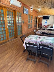 a room with two tables and chairs in a building at Pousada Agua Quente in Olímpia