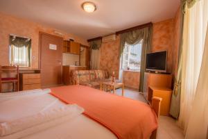 a hotel room with a bed and a television at Hotel Rendez Vous in Kotor