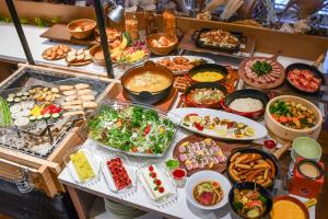 a buffet with many different types of food on a table at Hotel Edel Warme in Furano