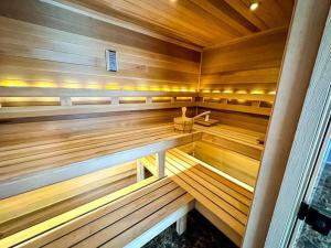 a large wooden sauna with a bench in it at Hot Tub Sauna Steam Room in East Stroudsburg