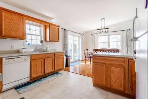 a kitchen with wooden cabinets and white appliances at My Blue Haven Game Area 4 BDR Pet Friendly in Albrightsville +36 photos