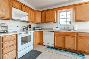 a kitchen with white appliances and wooden cabinets at My Blue Haven Game Area 4 BDR Pet Friendly in Albrightsville