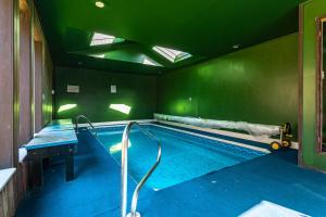 an indoor swimming pool with a pooliteratoriteratorhaarhaarhaarythonythonythonython at Heated Indoor Private Pool Stream Front Game Room in Cresco