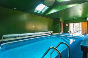 a large swimming pool in a house at Heated Indoor Private Pool Stream Front Game Room in Cresco +45 photos