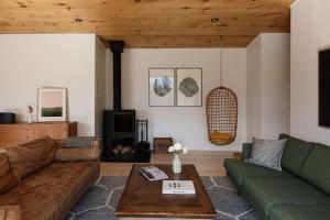 a living room with a couch and a table at Willow Creek - Modern Sunlit Bungalow in Hillier