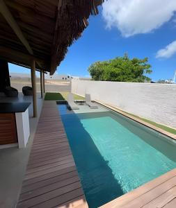 a swimming pool on the side of a house at Mar e descanso - São Miguel in Reduto