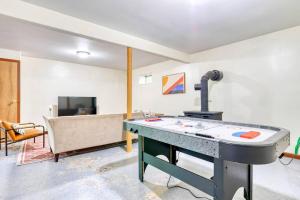a ping pong table in a room with a couch at 4BDR Hot Tub Game Room in Lake Ariel