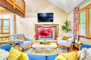 a living room with a couch and chairs and a tv at 4BDR Hot Tub Game Room in Lake Ariel
