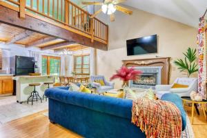 a living room with a blue couch and a fireplace at 4BDR Hot Tub Game Room in Lake Ariel +47 photos
