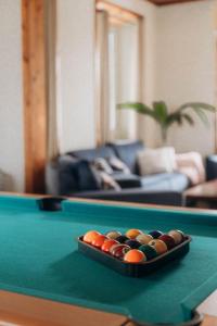 a tray of cue balls on top of a pool table at Oceanview Sunset Retreat in Pilar