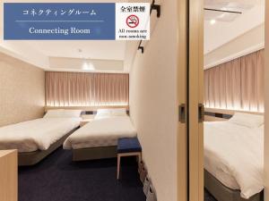 Ein Bett oder Betten in einem Zimmer der Unterkunft Henn na Hotel Premier Kagoshima Tenmonkan