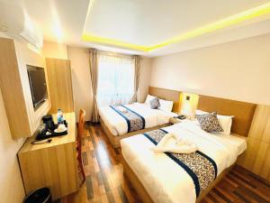 a hotel room with two beds and a television at Hotel Annapurna Palace in Kathmandu