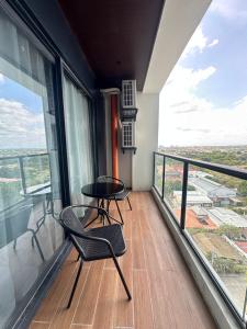a balcony with a table and chairs on a building at One Euphoria Luxe Hotel in Angeles