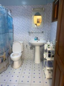 a bathroom with a toilet and a sink at Residence Adja Binta Kane Sour in Dakar +31 photos