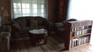 a living room with a couch and a coffee table at Rhulani Treetop Cottage in Marloth Park