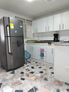 a kitchen with a stainless steel refrigerator in it at Donde Emilio in Pereira