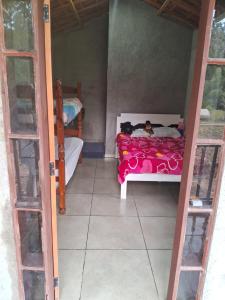 Cama ou camas em um quarto em Sítio Recanto das Jaboticabeiras