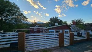 een wit hek voor een huis bij Altos de Grecia Cabaña 3 in Villa Carlos Paz