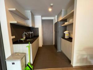 a small kitchen with a sink and a refrigerator at 23 Degree Khaoyai condo in Ban Huai Sok Noi