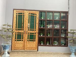 a wooden cabinet with potted plants in it at Visiting Villa in Srinagar