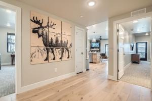 a living room with a painting of a deer on the wall at Flying Moose at Helling Circle 101 condo in Heber City