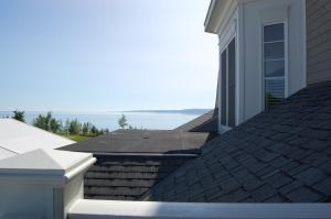 a roof of a house with the ocean in the background at The Inn at Cobble Beach in Kemble