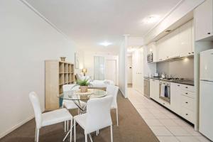 a kitchen and dining room with a table and chairs at A Comfortable Studio Near Darling Harbour in Sydney
