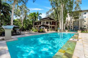an image of a swimming pool in front of a house at Paradise Bound - A Rooftop Resort Retreat in Palm Cove