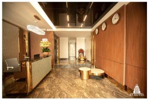 a lobby with a table and a bench in a room at X9 Hotel Luxury in Thuong Thon