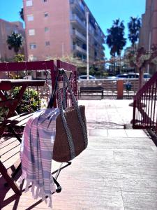 a purse is hanging on a park bench at Brisa Marina Stay a unos pasos del mar in Valencia
