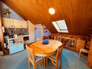 a large kitchen with a wooden table and chairs at Appartement pour 6 pers. à Autrans, proche ski - FR-1-737-95 in Autrans