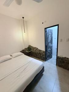 a bedroom with a bed and a glass door at Casa Encanto in Taganga +31 photos