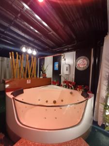 a large bath tub in a room with at BMF Homestay Jacuzzi in Tacloban