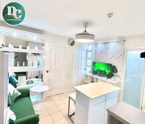 a living room with a couch and a tv at COZYTEL Centro in Davao City