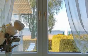 a glass door with a view of the water at Ferienhaus Kummerow in Kummerow +19 photos