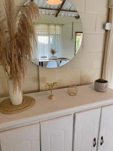 a room with a counter with a mirror and a table at La Morada Quindio cabaña campestre in Boquía