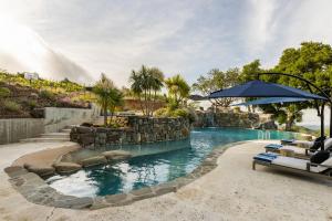 a pool at a resort with chairs and an umbrella at Montebello Views in Cupertino