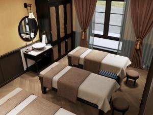 a room with three beds and a sink and a mirror at Halong Collection Of The Sea Cruises in Ha Long