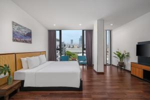 Postel nebo postele na pokoji v ubytování Platinum Danang Hotel