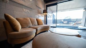 a living room with two chairs and a couch at Mayu Futahari in Nishiizu