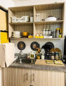 a kitchen with a sink and a counter top at Staycation Marilao Bulacan in Marilao